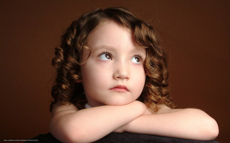 child with curly hair looking up