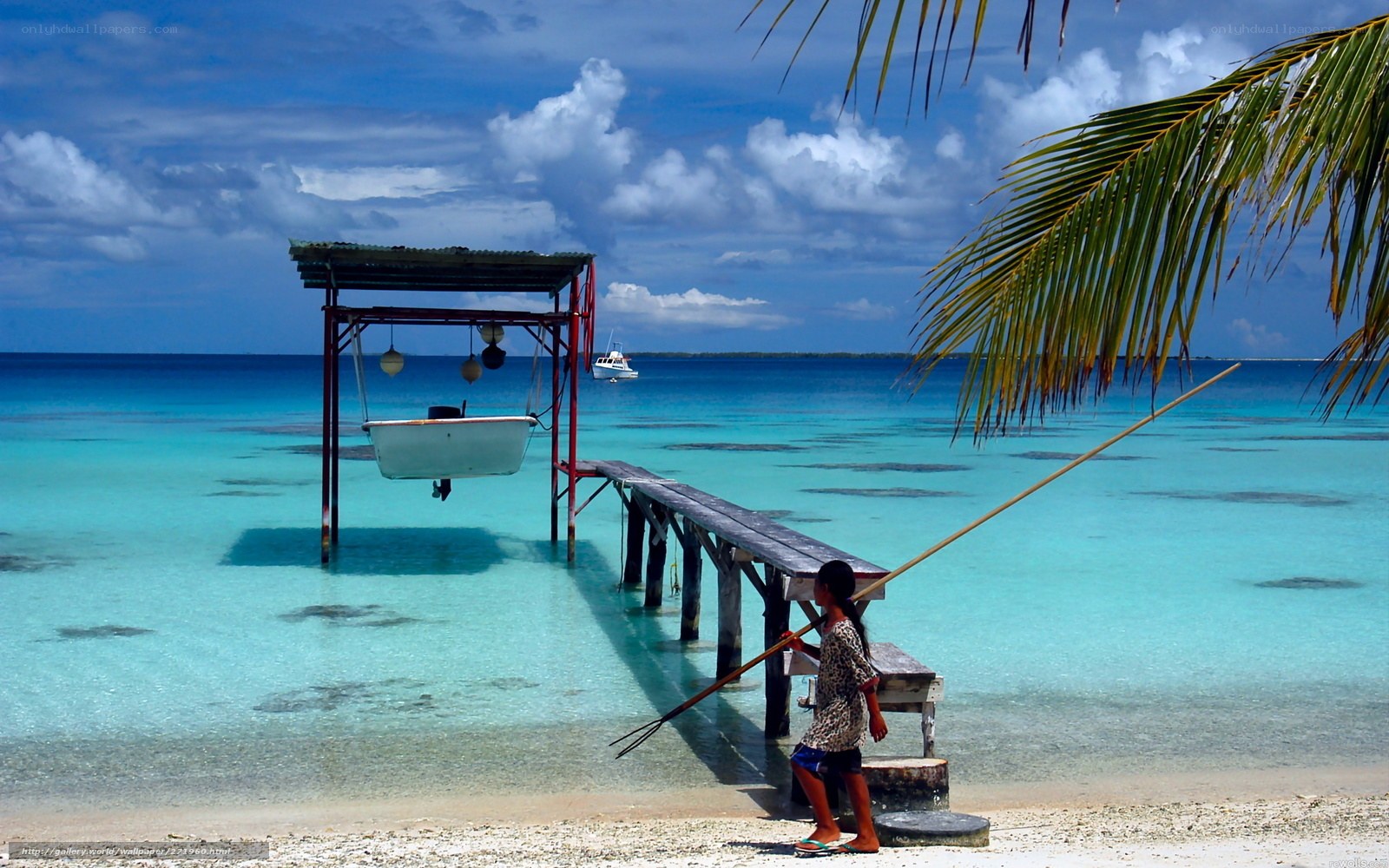 Child with fishing spear on tropical beach