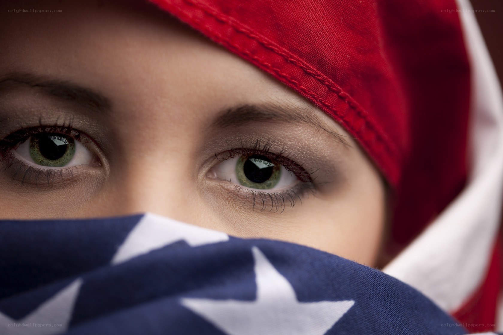 child with flag covering face