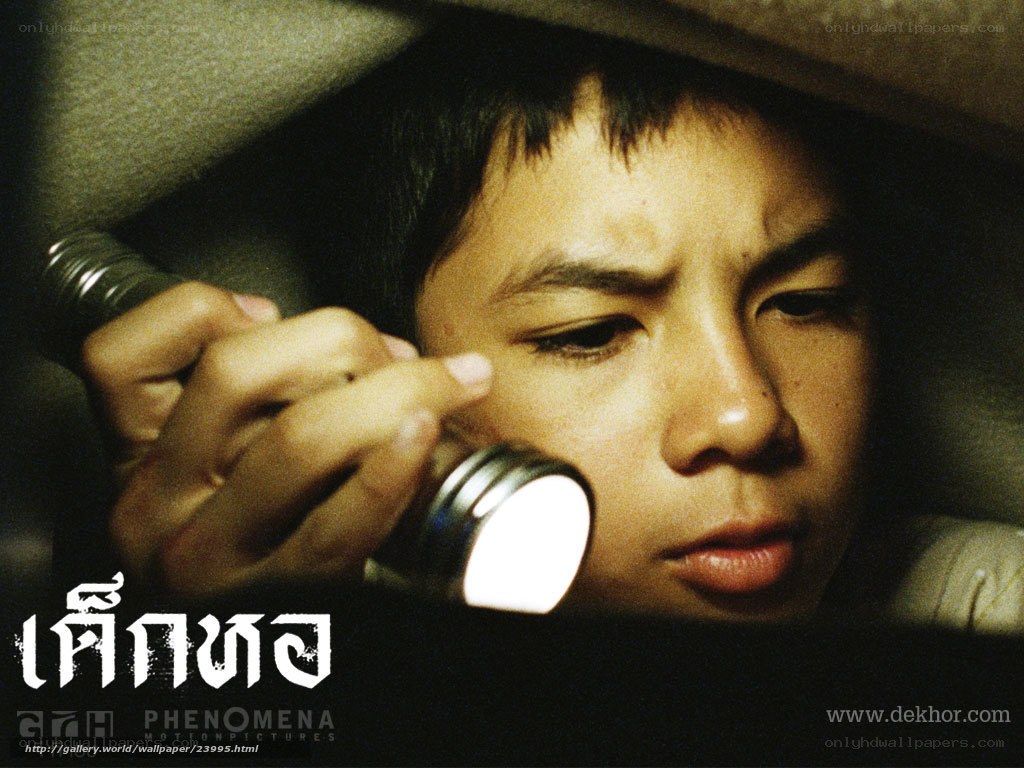 child with flashlight in dark