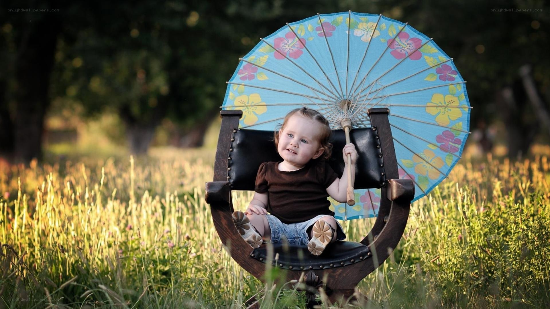 Child with floral umbrella in field