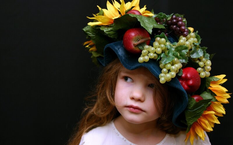 child with fruit and flower crown
