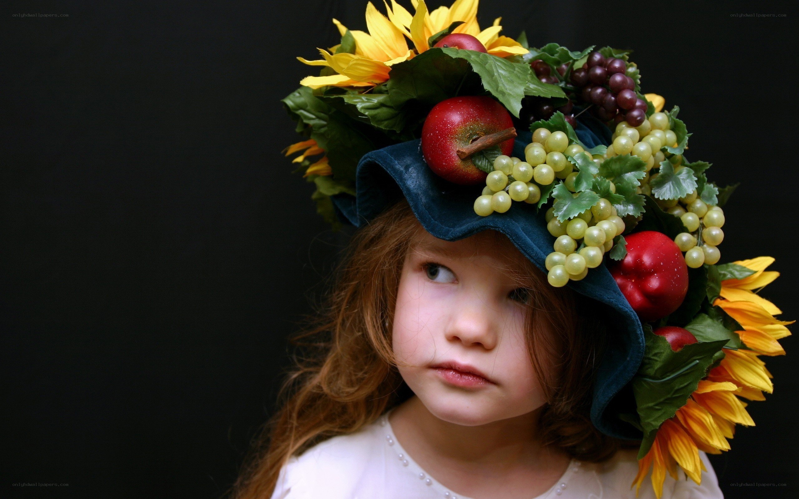 child with fruit and flower crown