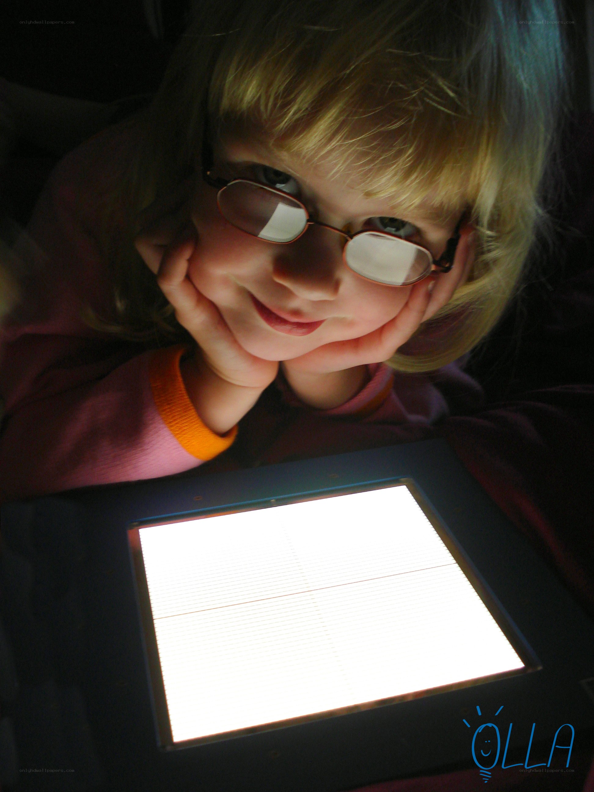 child with glasses on tablet