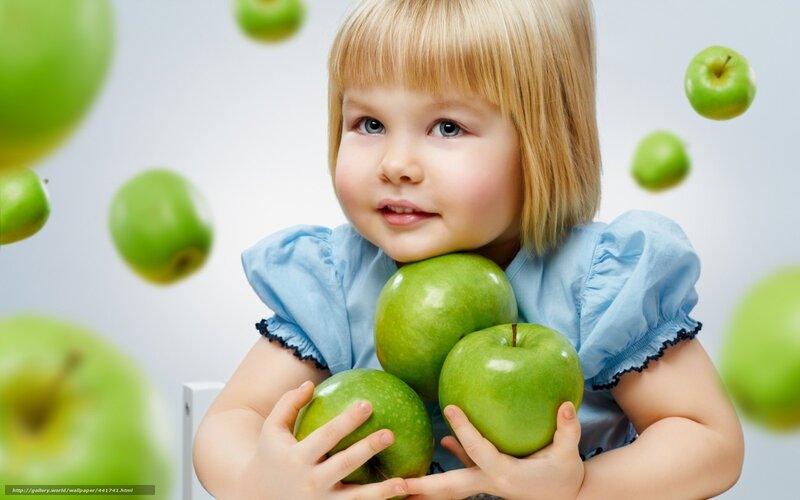 child with green apples