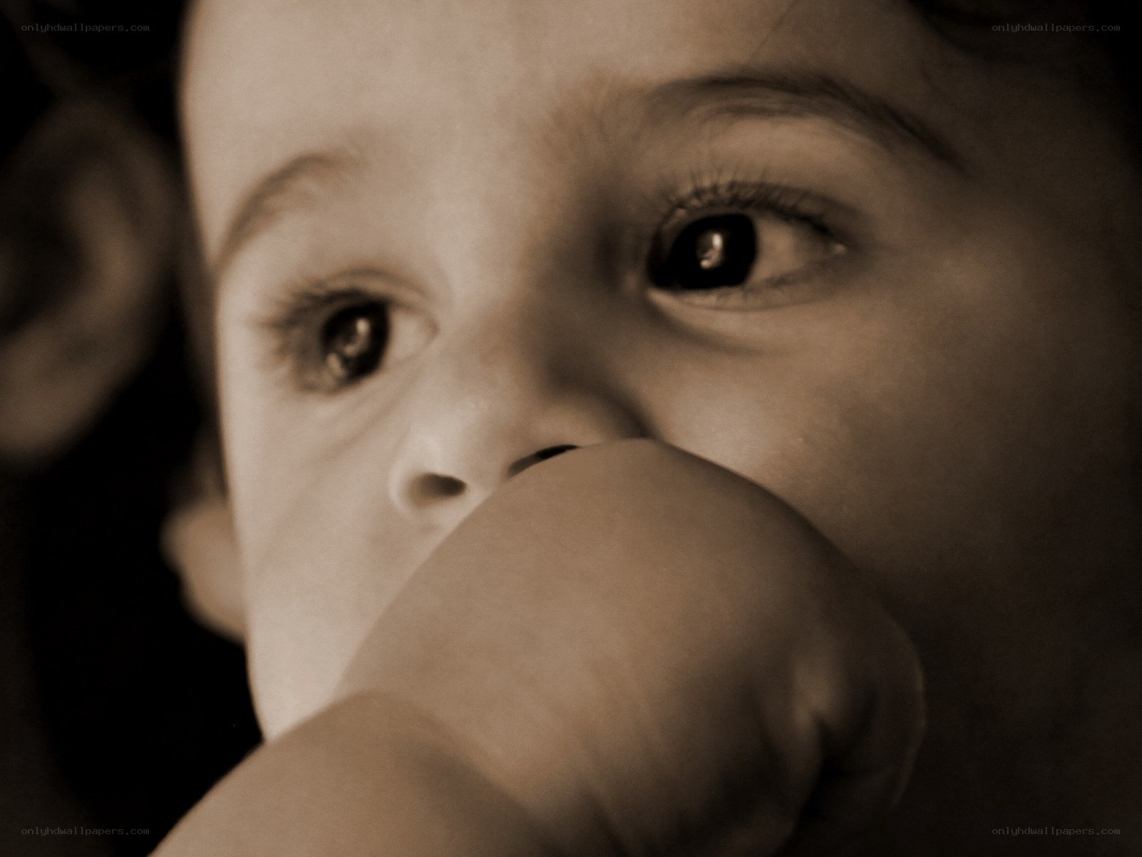 child with hand near face