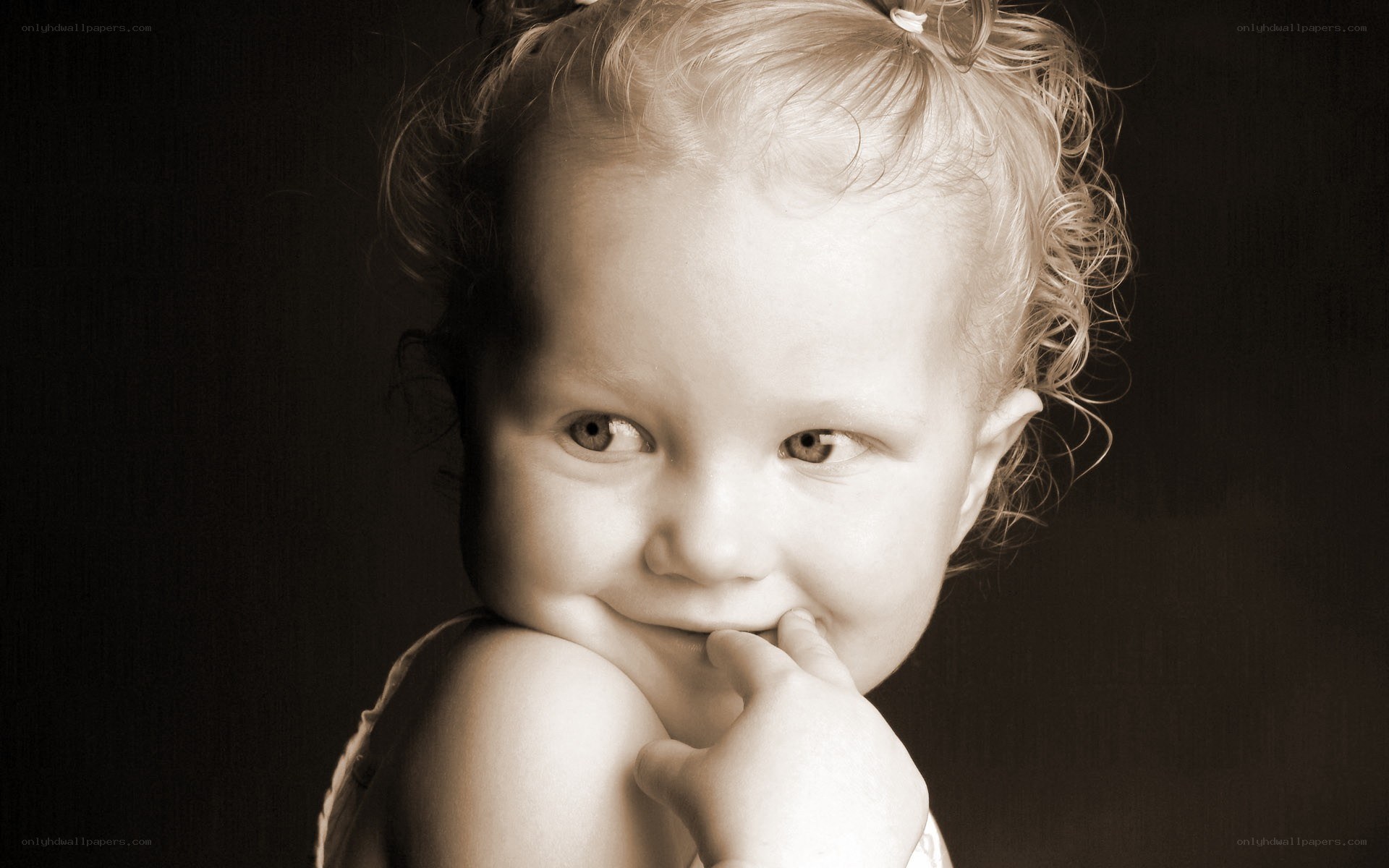 child with hand on chin