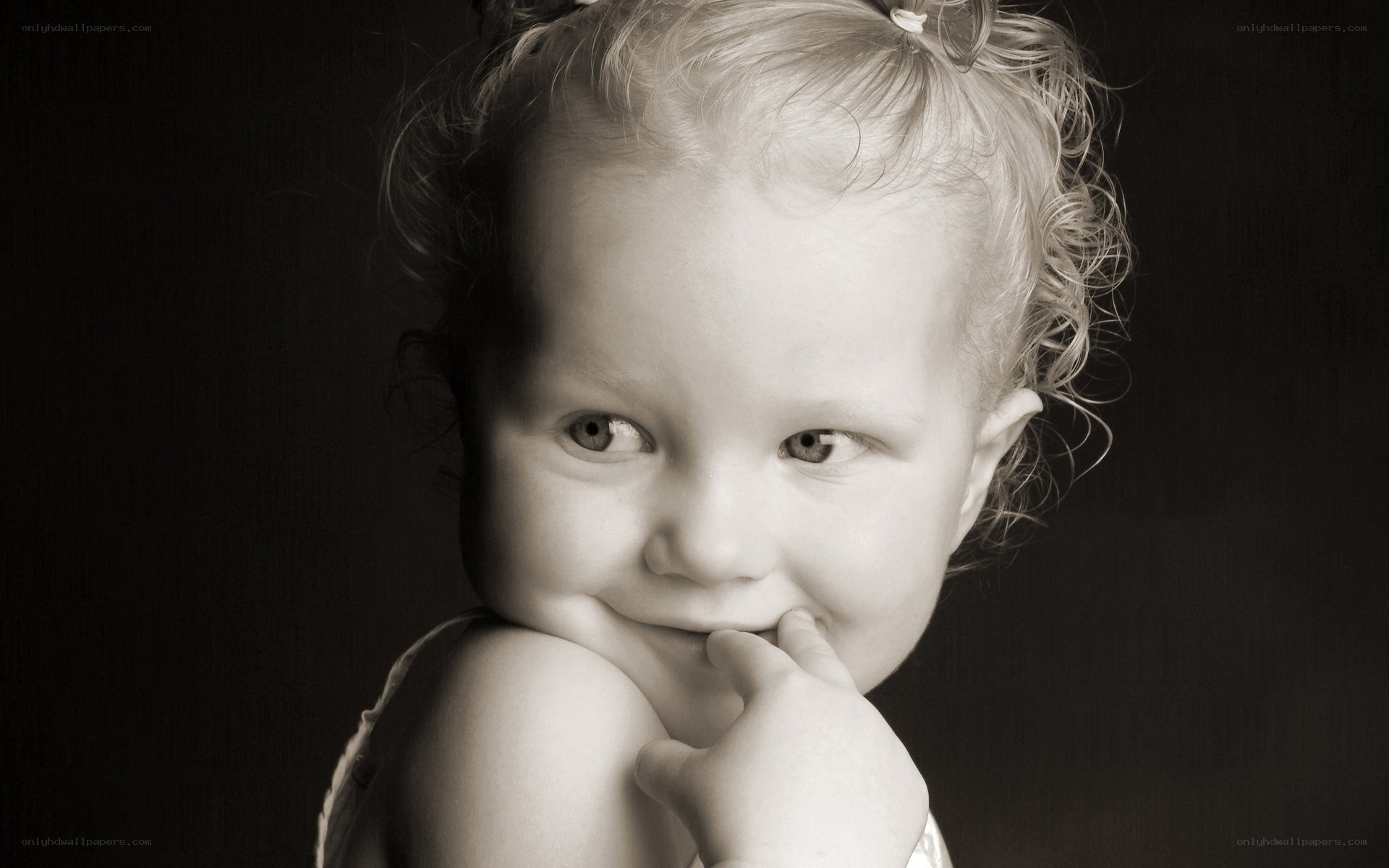 child with hand on chin
