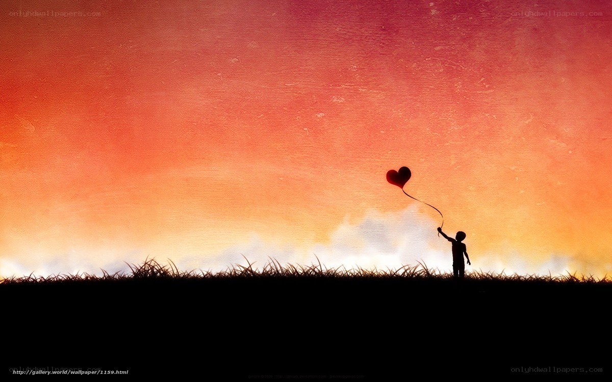 Child with heart balloon at sunset