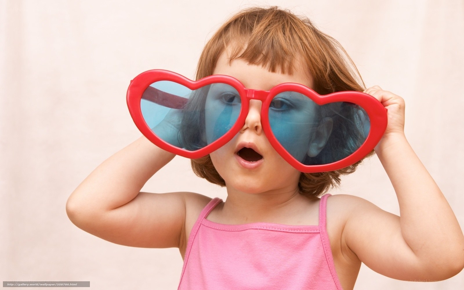 child with heart-shaped glasses