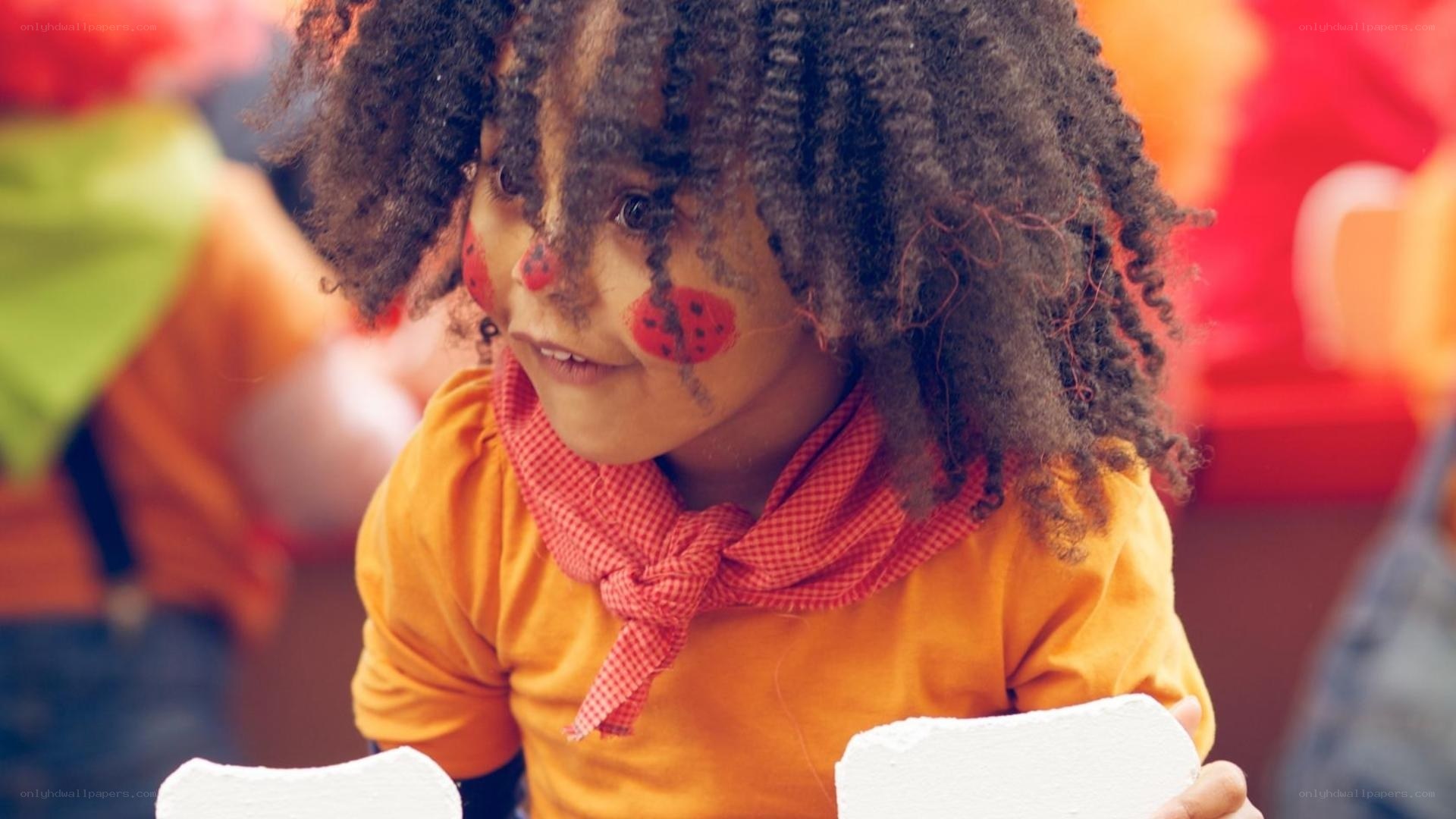 child with ladybug face paint