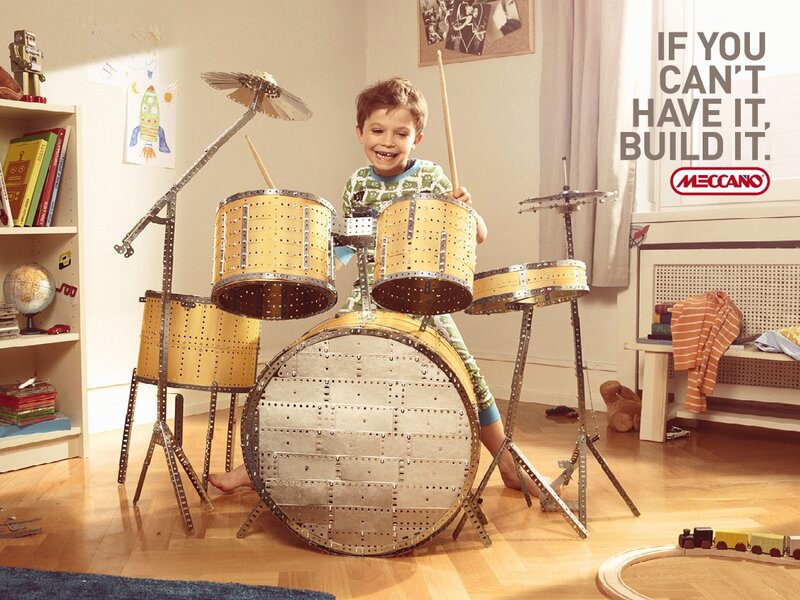 child with meccano drum set