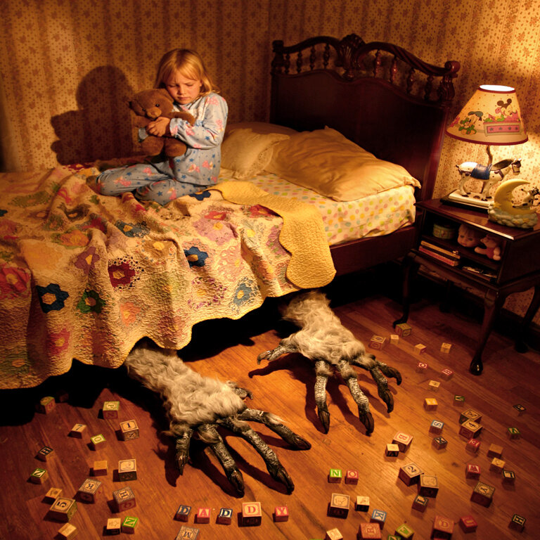 Child with monster feet in bedroom