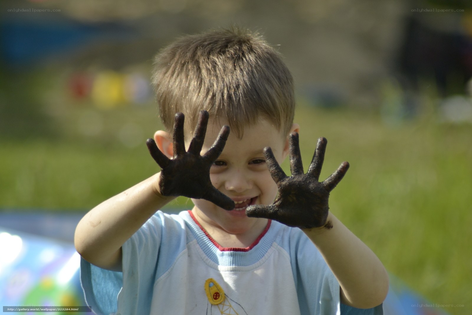 child with muddy hands