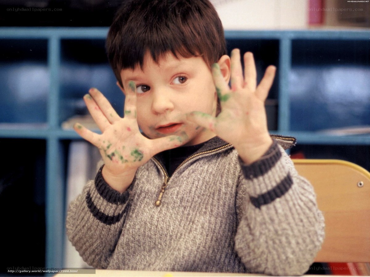 child with paint-covered hands