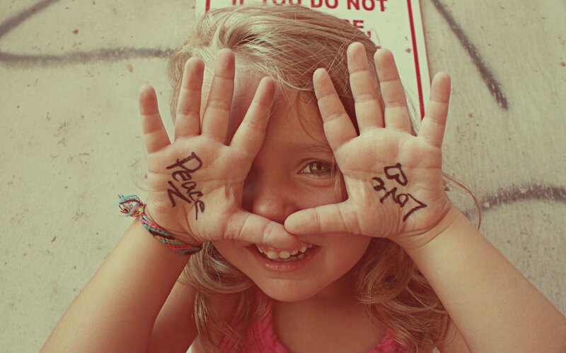 child with peace hands