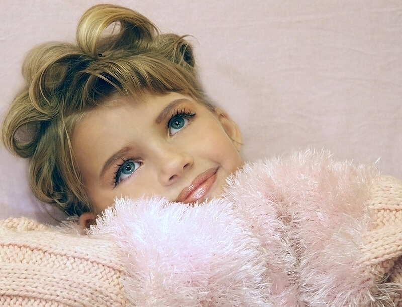 child with pink blanket