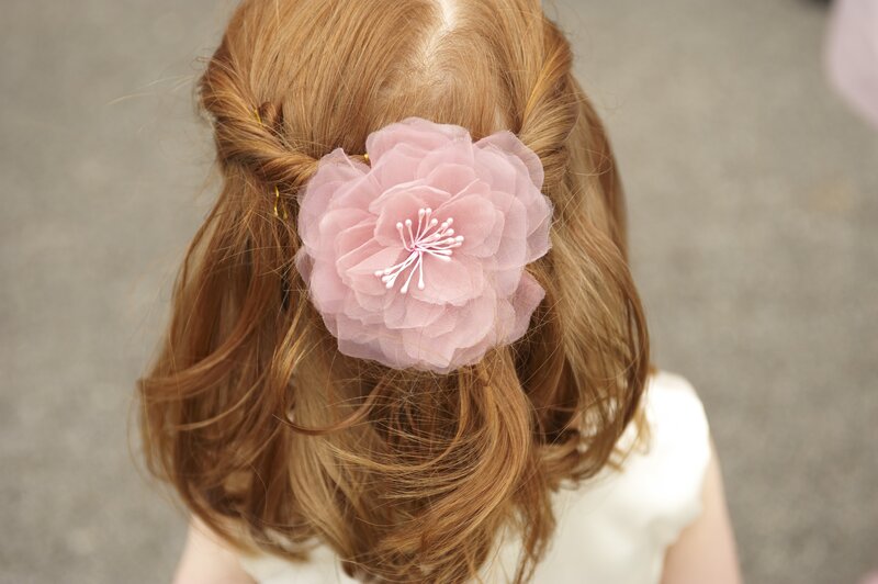 Child with Pink Flower Hair Clip