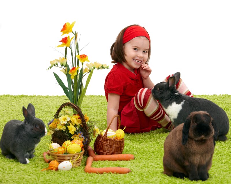 child with rabbits and easter eggs