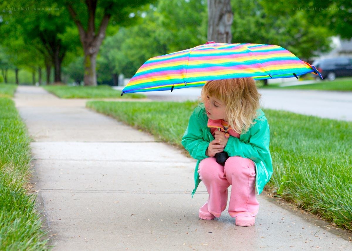 child with rainbow umbrella