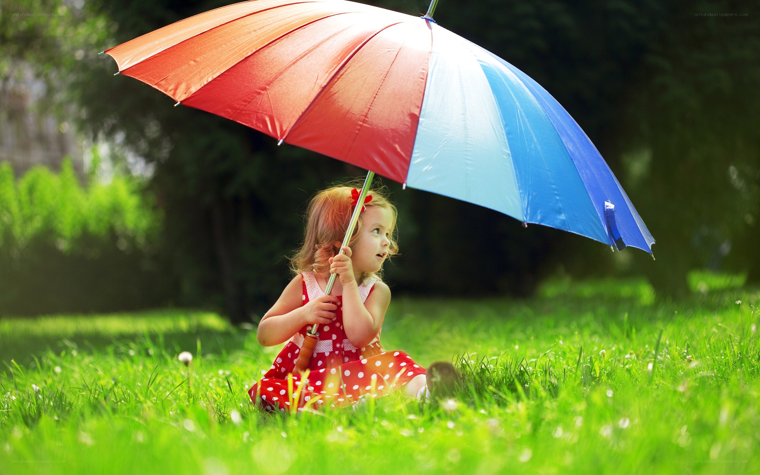 child with rainbow umbrella