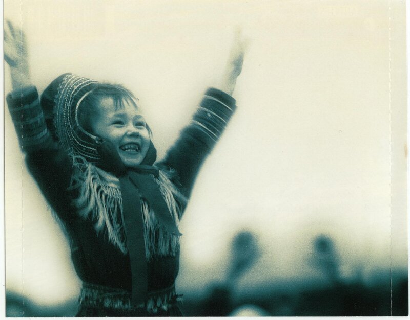 child with raised arms