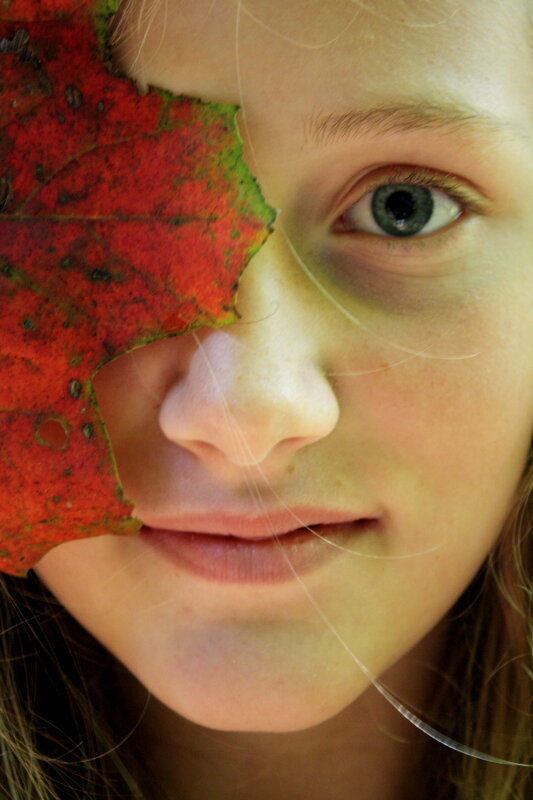 child with red leaf