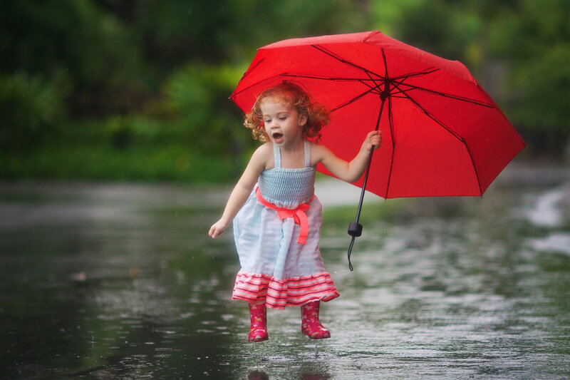 Child with Red Umbrella — Playful