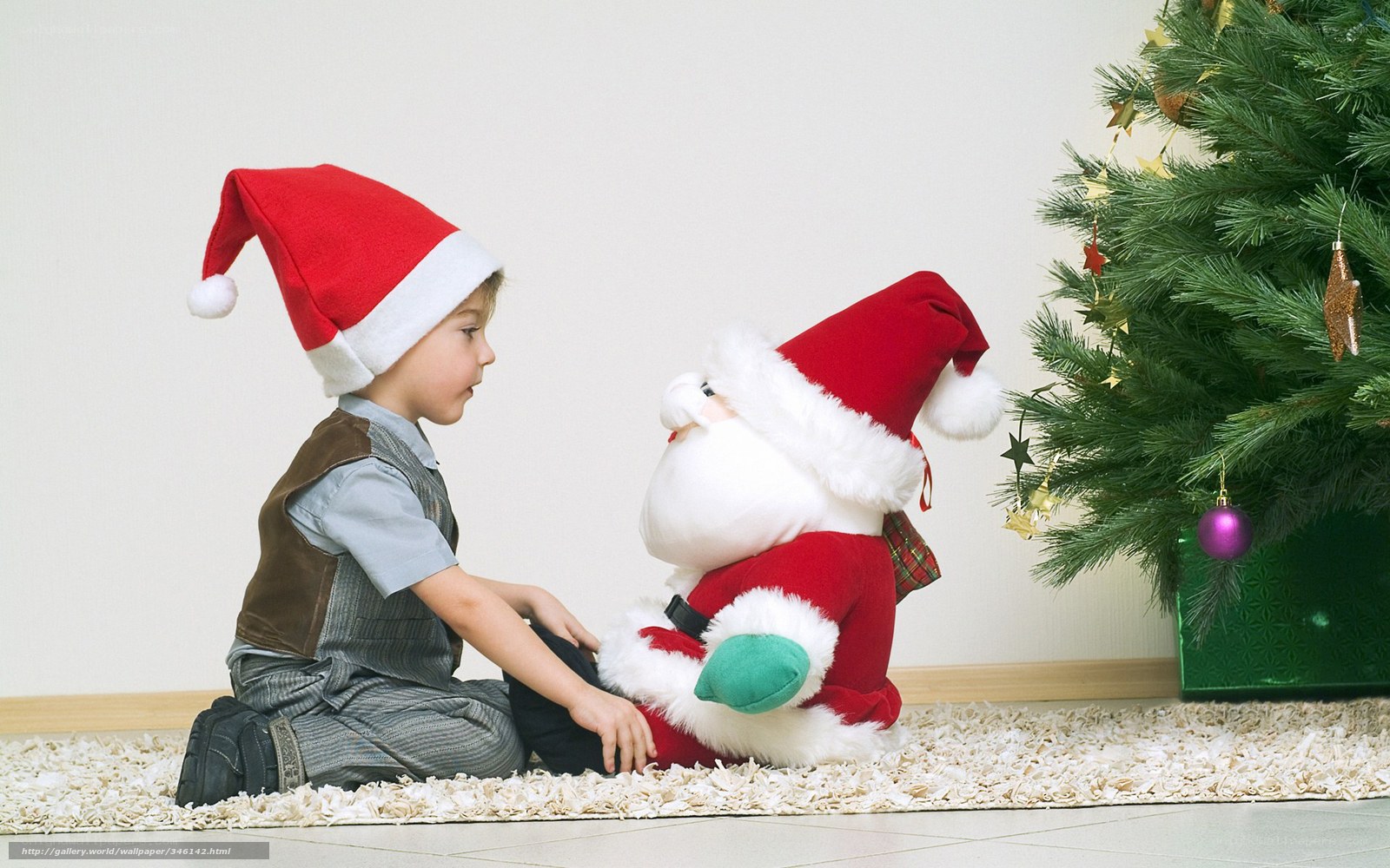 child with santa plush toy