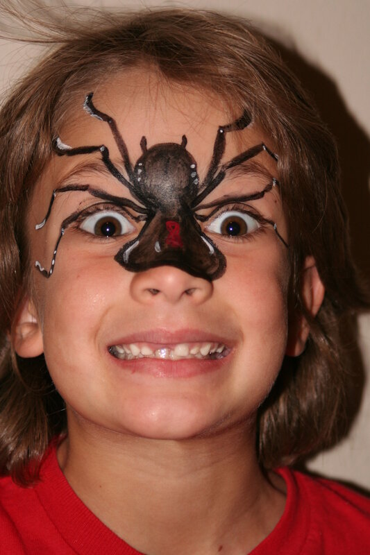 child with spider face paint