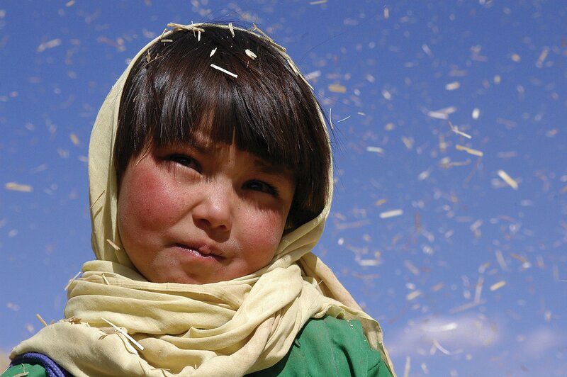 child with straw in hair