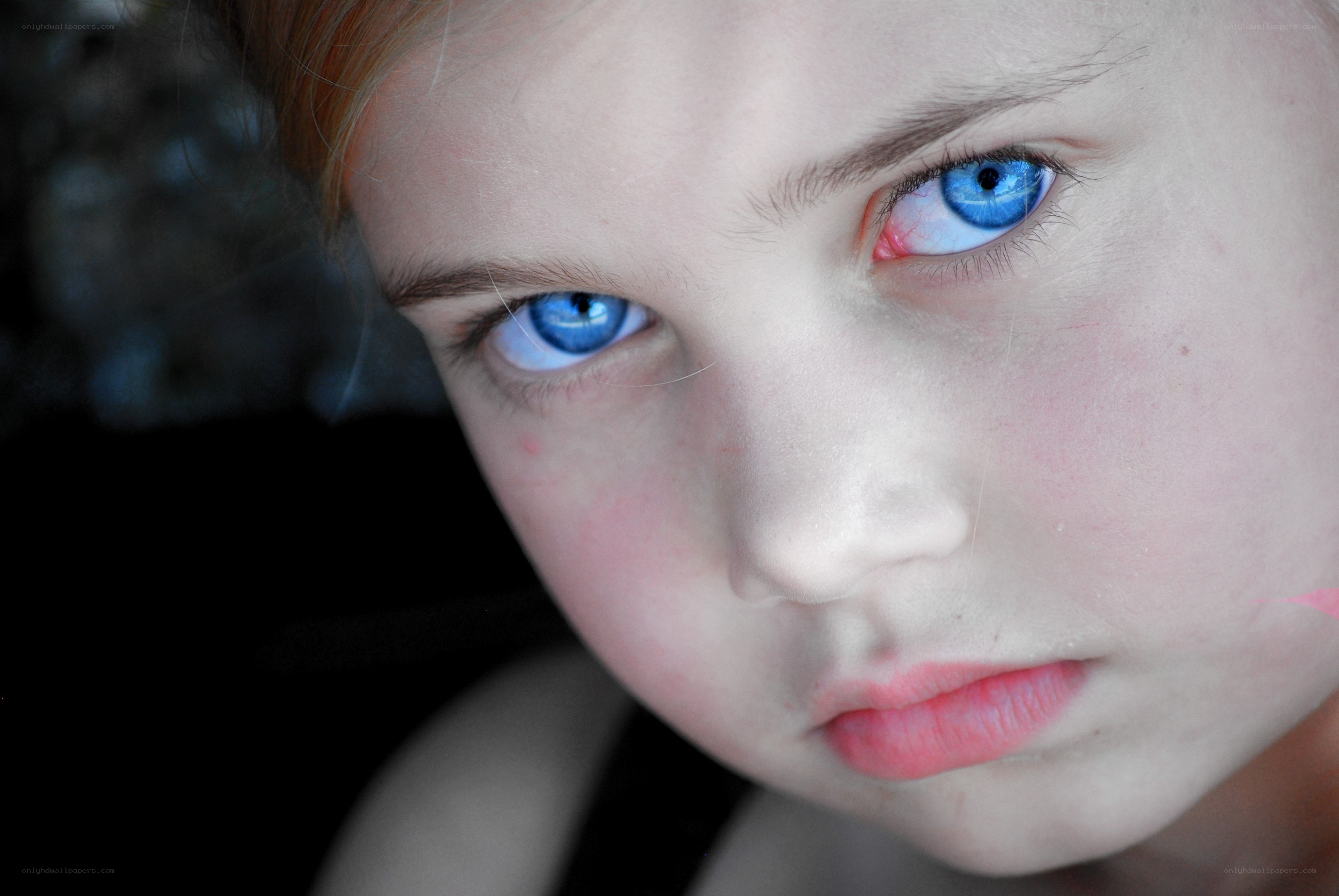 child with striking blue eyes