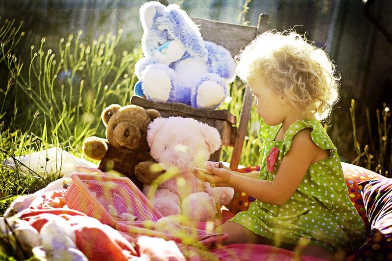 Child with Stuffed Animals — Green