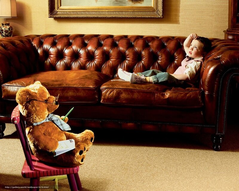 Child with teddy bear on sofa