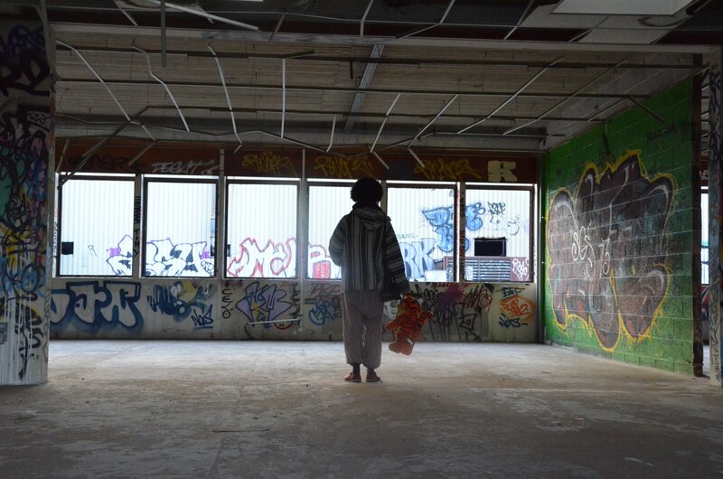 Child with toy in abandoned building