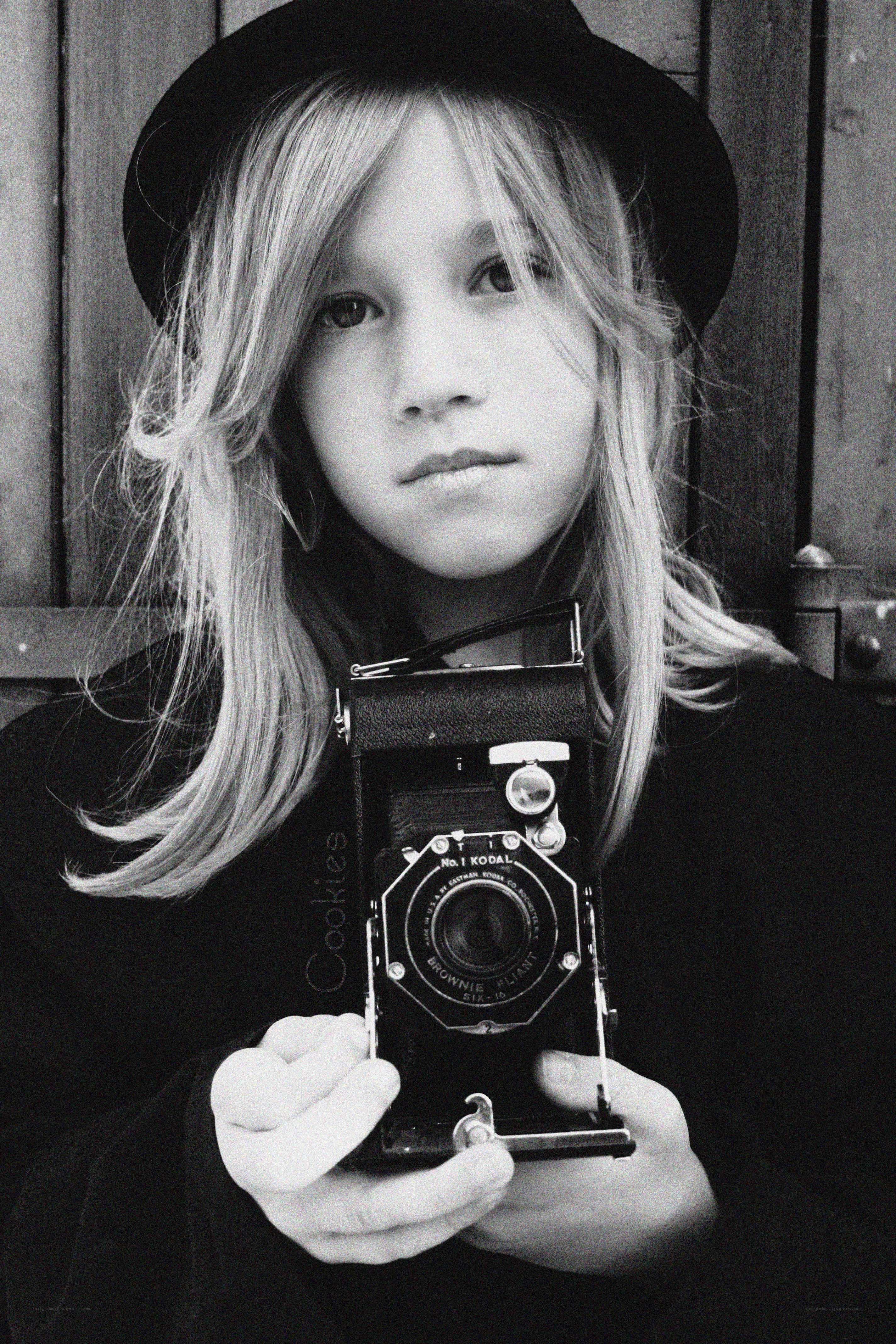 child with vintage camera