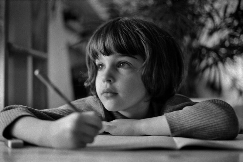 child writing at a desk