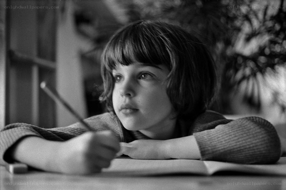 child writing at a desk