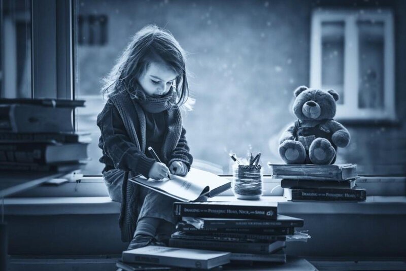 Child Writing at Desk — Blue