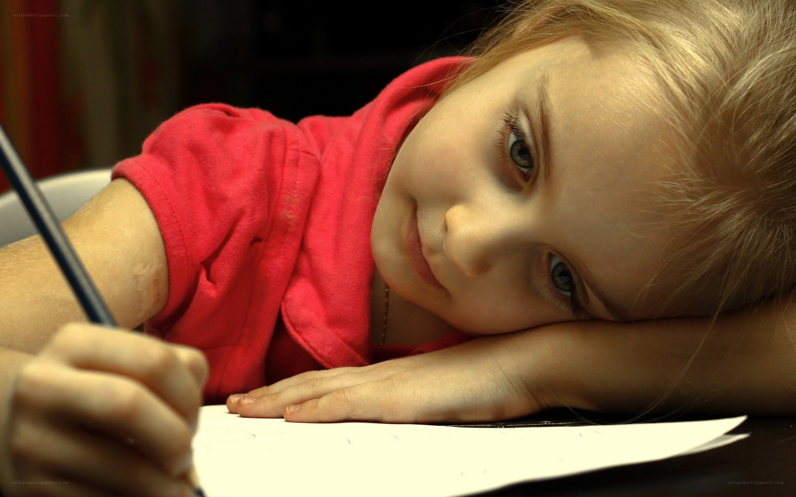 child writing at desk