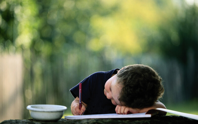 Child Writing at Table