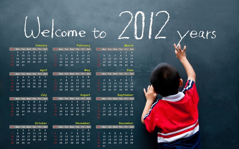 Child writing calendar on chalkboard