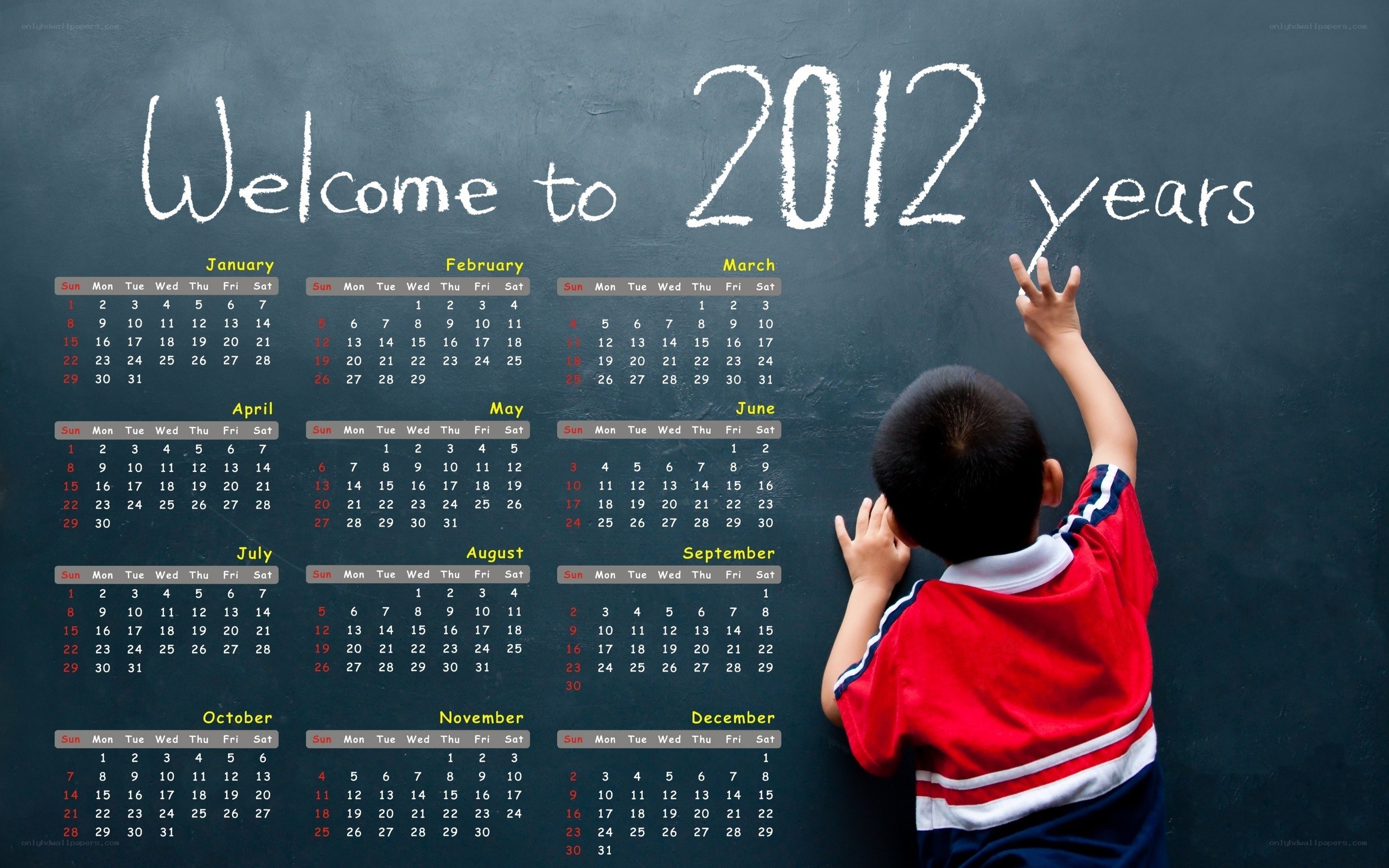 Child writing calendar on chalkboard