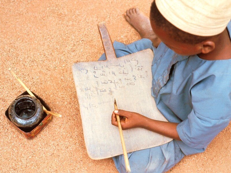 child writing on a board