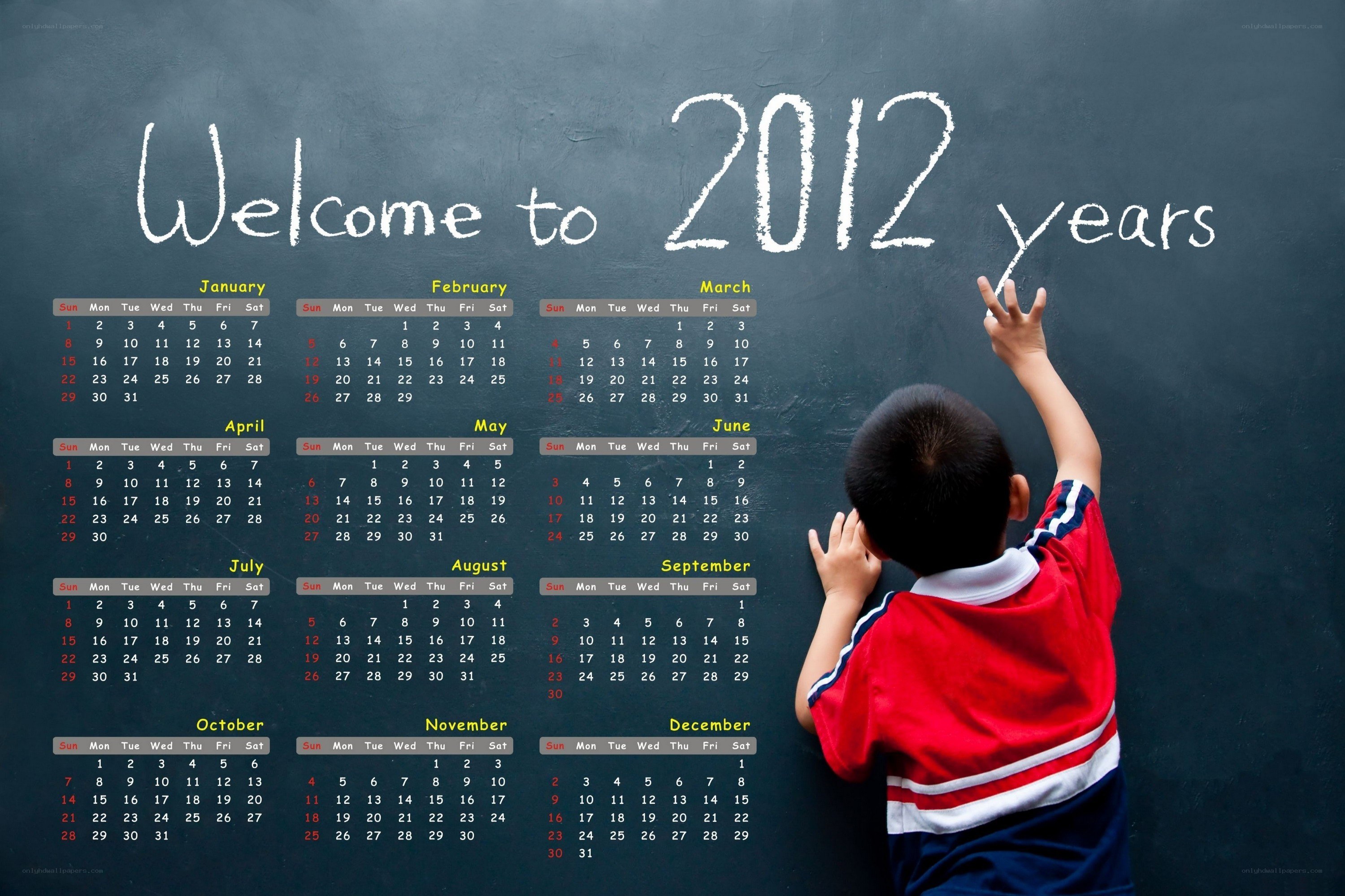 Child writing on chalkboard calendar