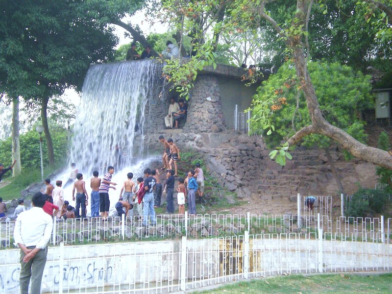 Children at a park waterfall