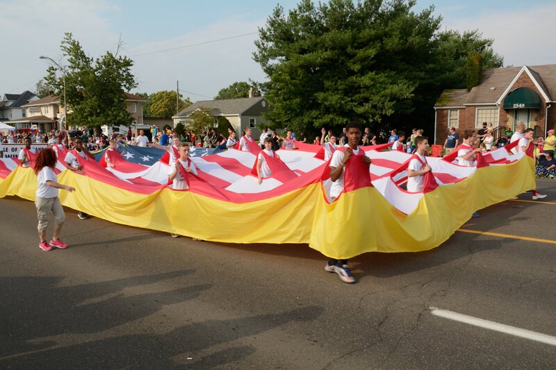Children Carrying Large Flag