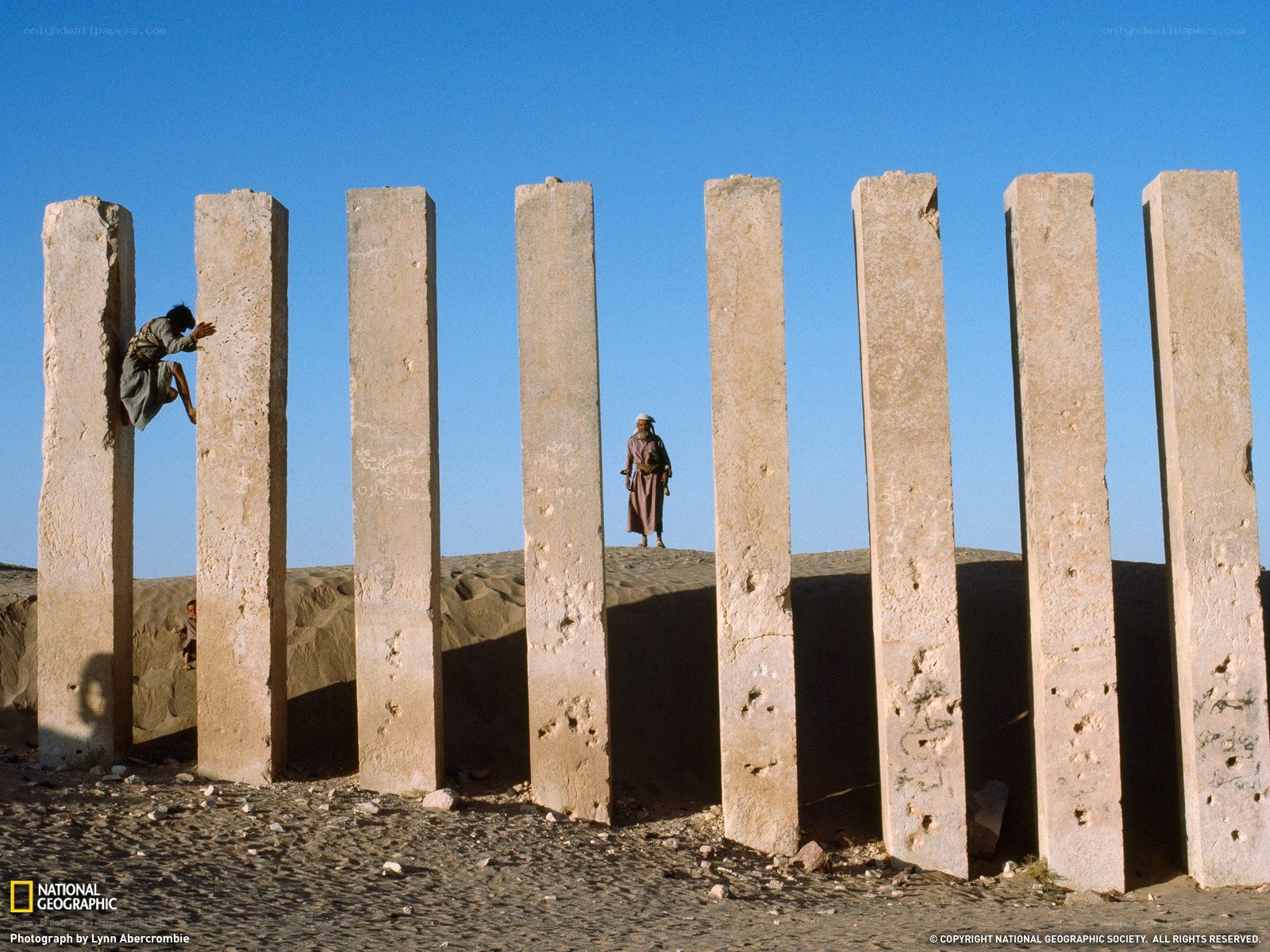 Children climbing ancient pillars