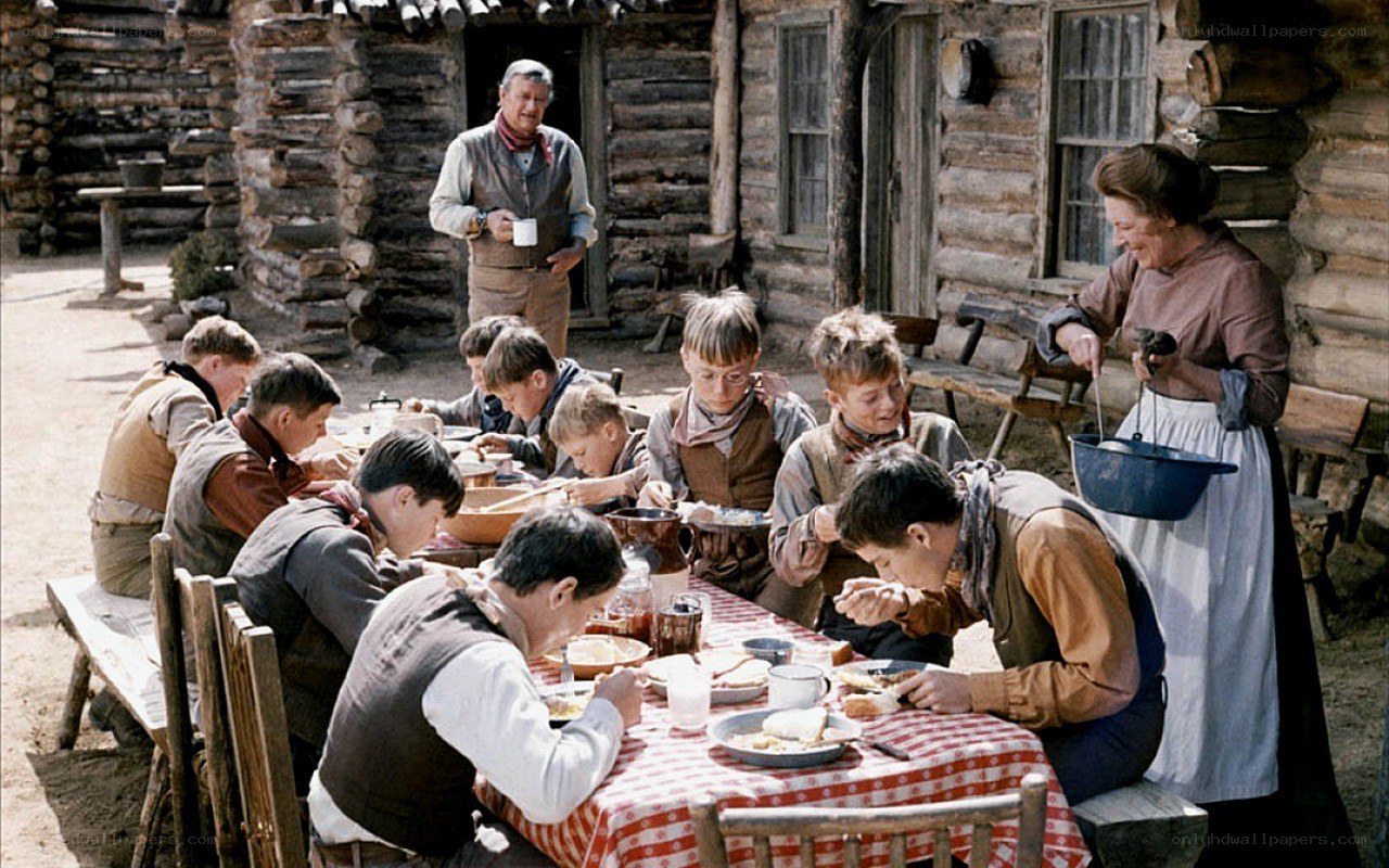 Children eating at a log cabin