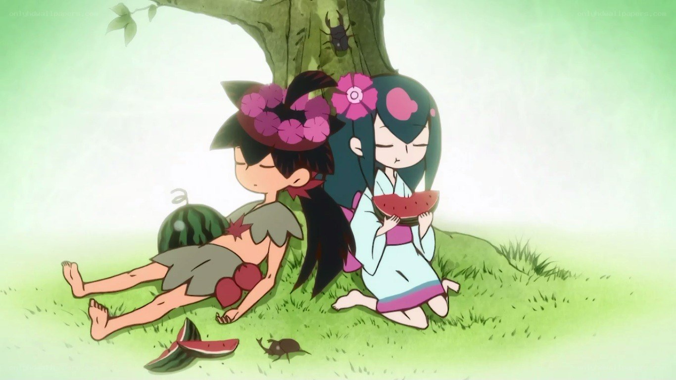 Children eating watermelon under a tree